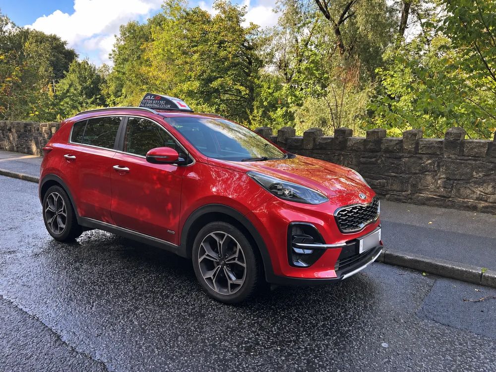 Red ALD Driving School tuition car with branded roof sign